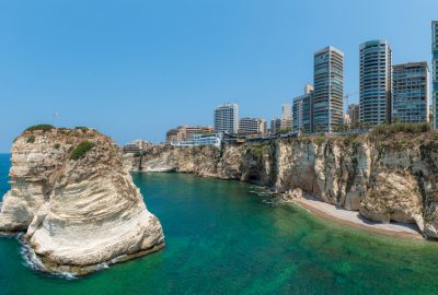 Beirut city guide.Raouche Rocks.01 view of Raouch Rocks in the sea and skyscrapers of Beirut
