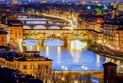Florence city guide.Ponte Vecchio.01 Panoramic view of the bridge Ponte Vecchio in Florence with night illumination