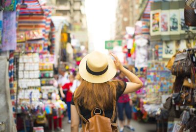 Hong Kong city guide.Mong Kok district.01 Tourist shopping at market in Mong Kok district of Hong Kong