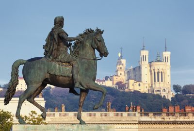 Lyon city guide.statue of Louis XIV.02 A statue of King Louis XIV and the Basilica of Notre-Dame de Fourvière at the background
