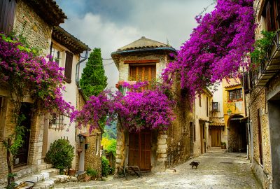 Nice city guide.village in Provence.01 Yellow house wreathed with bougainvillea in village close to Nice