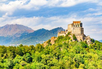 Turin city guide.Sacra di San Michele.02 Sacra di San Michele on top of a green mountain near Turin