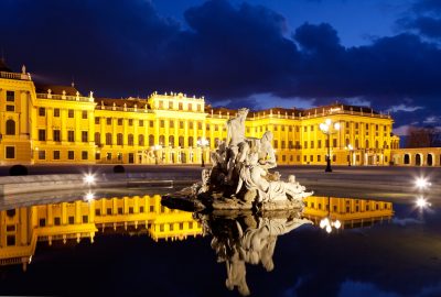 Vienna city guide.Schloss Schonbrunn.02 Schonbrunn palace in Vienna by night with fountain in the foreground