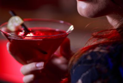 Filipino woman sipping cocktail in Manila bar