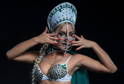 Girl in traditional Russian outfit during show in Moscow striptease club
