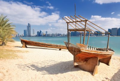 Abu Dhabi city guide.boats.01 Wooden boats at beach with Abu Dhabi skyline at backdrop