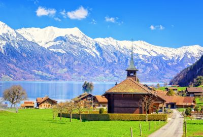Bern city guide.wooden church.02 Wooden church to the backdrop of the Swiss Alps in Bern's countryside