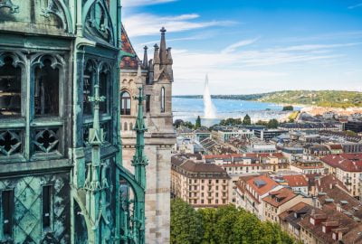 Geneva city guide.St. Pierre Cathedral.01 Gothic facades of St. Pierre Cathedral with Lake of Geneva at the backdrop