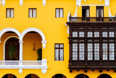 Lima city guide.Palacio Municipal de Lima.02 Bright yellow facade and balconies of the Palacio Municipal de Lima