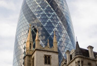 London city guide.The Gherkin.02 30 St Mary Axe aka The Gherkin in the City of London City with historical buildings at the forefront