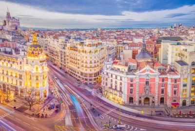 Madrid city guide.Calle de Alcala and Gran Via.01 Intersection of the Calle de Alcala and Gran Via in Madrid when evening kicks in