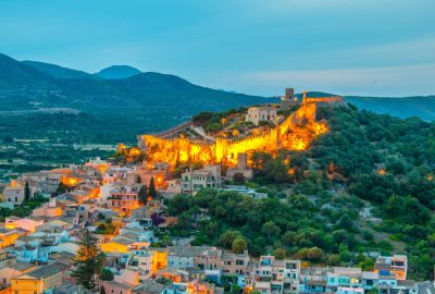 The walled fortress Castell de Capdepera illuminated at evening on the island of Majorca