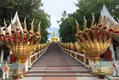 Pattaya city guide.Big Buddha Temple.01 Golden Big Buddha statue and staircased flanked by dragons on top of Pratumnak Hill near Pattaya