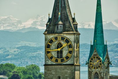 Zurich city guide.Fraumunster and St. Peter Church.02 The towers of the Fraumunster and St. Peter Church in Zurich with the snow tops of the Swiss Alps at the background