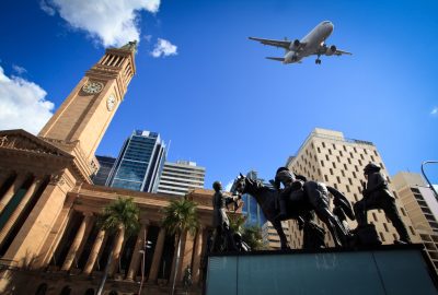 Brisbane-city-guide.City-Hall-and-King-George-Square.01 View of City Hall and King George Square in Brisbane with a plane flying over them