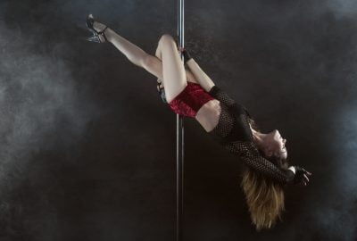 Dancer swinging around pole in Dubrovnik striptease club