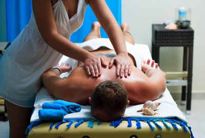 Male client getting back and shoulders massage in salon in Liege