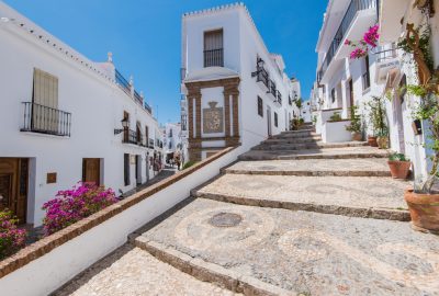 Malaga city guide.pueblo blanco of Frigiliana.02 Charming narrow historic street of the white village of Frigiliana in the province of Malaga, Andalusia