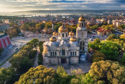 Varna city guide.Dormition of the Mother of God Cathedral.01 Varna's Dormition of the Mother of God Cathedral with Black Sea and port area on the background